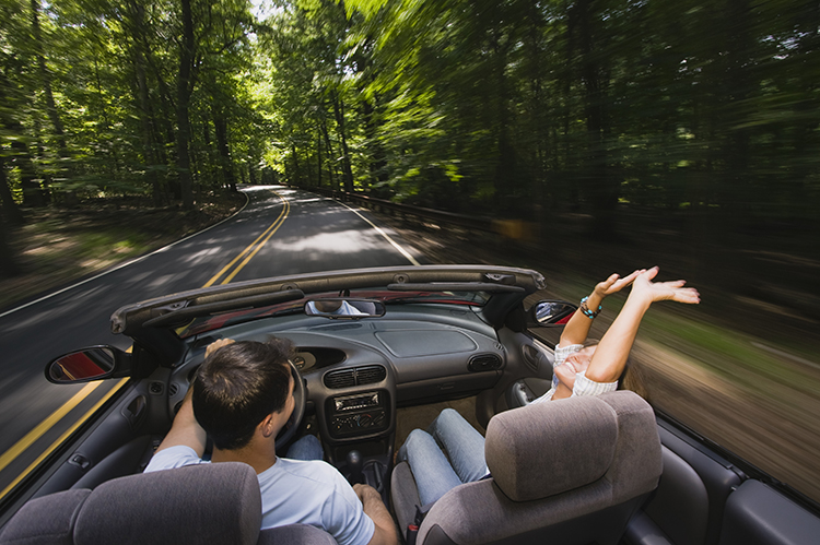 people driving in a convertable 